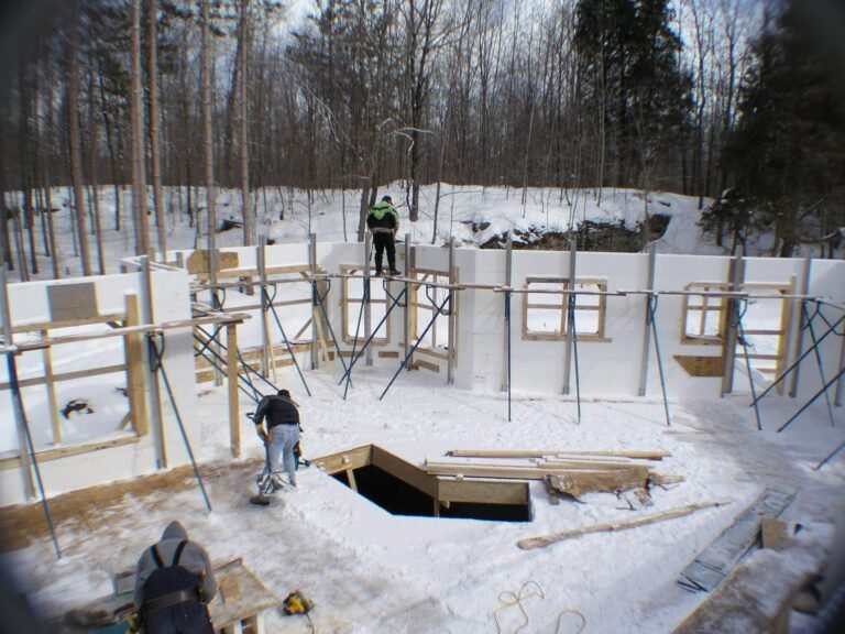 ICF walls being stacked and braced on a winter job site